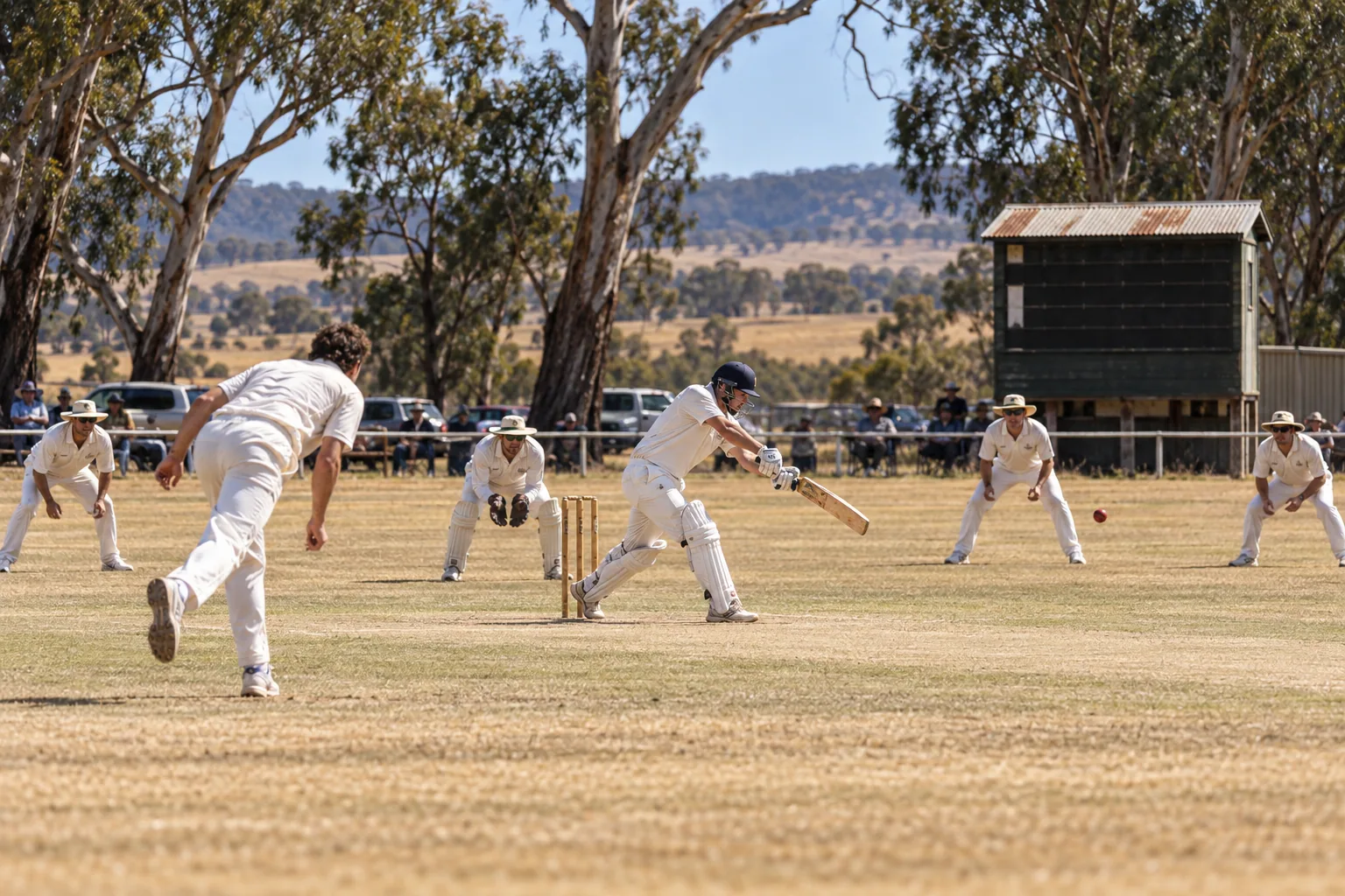 A country cricket ground on a hot summer afternoon